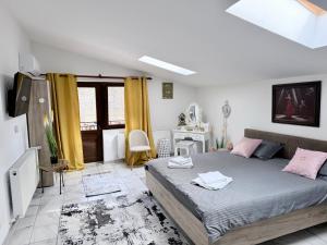 a bedroom with a large bed and yellow curtains at Casa Cernica in Cernica