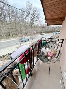 a teddy bear sitting in a chair on a balcony at Casa Cernica in Cernica