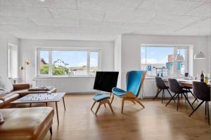 a living room with a couch and chairs and a table at 717-Thyboron-Jernbanegade-3 in Thyborøn