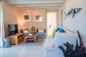 a living room with a couch and a tv at Irini's Bayside Loft in Fiskardo