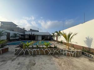 a resort with a swimming pool and a building at Casa Yangu in Watamu