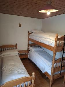 two bunk beds in a room with a ceiling at Campiglio Trilocale Cima Tosa in Madonna di Campiglio