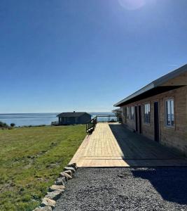 a wooden walkway leading to a building on a beach at Motel Seal Rock in Perce