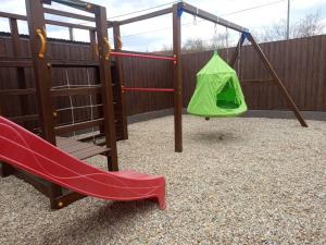 a playground with a slide and a swing set at President Apartmanház - Nincs szomszéd - Egy időben,egy társaság - in Békéscsaba
