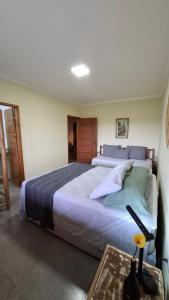 a bedroom with a large bed and a table at Casa do Brother in Prado