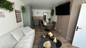 a living room with a couch and a table at Family in Calais