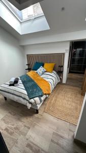 a bedroom with a bed and a skylight at Family in Calais