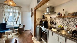 a kitchen with a sink and a counter top at Belle échappée in Le Crotoy