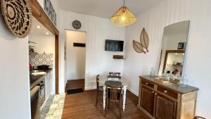 a kitchen with a table and a dining room at Belle échappée in Le Crotoy +2 photos