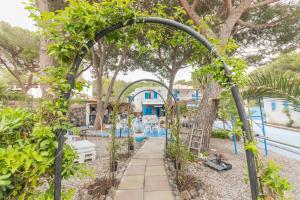 a garden with an archway and a playground at Holiday Eolie Village in Vulcano
