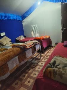 a room with two beds in a room at Shivpuri Hills Camp in Jāmb