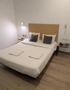 a bedroom with a large white bed with two pillows at Hotel BR international in Tājganj