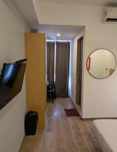 a room with a mirror and a room with a bed at Hotel BR international in Tājganj