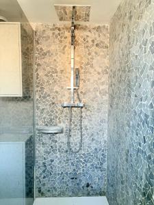 a bathroom with a shower with a glass door at MiMa Vakantiewoning bij Tomorrowland in Boom +10 photos