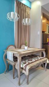 a dining room table with two chairs and two lights at Maison Brise Condominium Unit Pico De Loro Nasugbu in Nasugbu