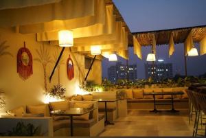 a restaurant with couches and tables in a room at Hotel BR international in Tājganj