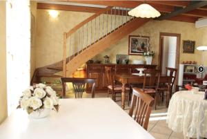 a kitchen and dining room with a table and a staircase at Camera Lucy in Bardolino