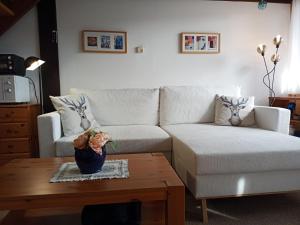 a living room with a couch and a coffee table at Ferienwohnung Teddy in Siegsdorf