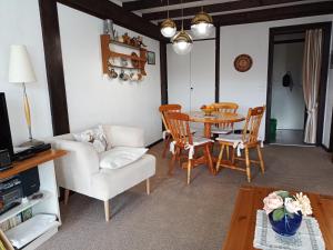 a living room with a table and chairs at Ferienwohnung Teddy in Siegsdorf
