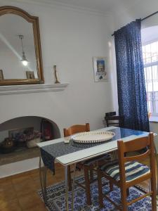 a dining room with a table and chairs and a mirror at Evangelia in Symi