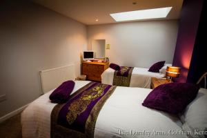 
a hotel room with a bed and a desk at The Darnley Arms in Gravesend
