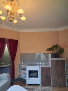 a living room with a fireplace and a chandelier at Singel room in big house in Molkom +13 photos