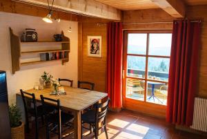 a dining room with a wooden table and a window at Gibbesbachhof Black Forest Apartments in Triberg