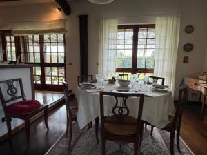 a dining room with a table with wine glasses on it at Il Giardino di Dede in Ferrara