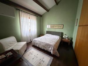 a bedroom with a bed and a couch at Il Giardino di Dede in Ferrara
