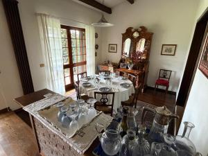 a dining room with a table with glasses on it at Il Giardino di Dede in Ferrara +17 photos