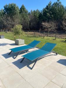 two blue lounge chairs sitting on a patio at Villa Caplanne in Sanguinet