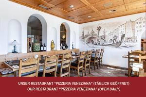 a restaurant with a mural on the wall at Hotel Vorab - Familienbetrieb mit Herz in Flims