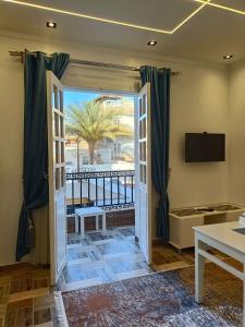 a room with a door open to a balcony at Villa golden life apartments, new property with pool access in Luxor
