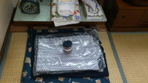 a suitcase is wrapped in tin foil on the floor at Mimatsuso Ryokan in Asahikawa