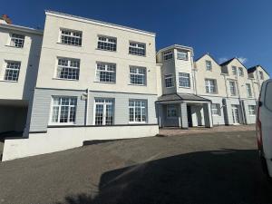 a large white building with a lot of windows at Pool table-Pet Friendly-Beach access-Garden in Trearddur