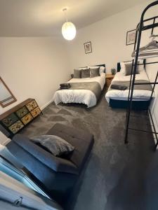 two beds in a room with two bunk beds at Pool table-Pet Friendly-Beach access-Garden in Trearddur