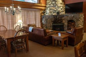 a living room with a couch and a fireplace at Mike Wiegele Helicopter Skiing in Blue River