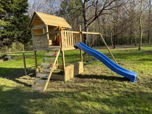 a wooden playground with a slide and a play structure at Les Gîtes de La Pellerie - 2 piscines intérieur & extérieur - Touraine - 3 gîtes - familial, calme, campagne in Saint-Branchs