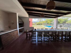 a large dining room with a long table and chairs at Casa con pileta cerca de Salta in Salta