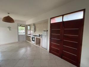 a kitchen with a large wooden door in a room at Casa con pileta cerca de Salta in Salta