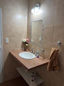 a bathroom with a sink and a mirror at Casa con pileta cerca de Salta in Salta +26 photos
