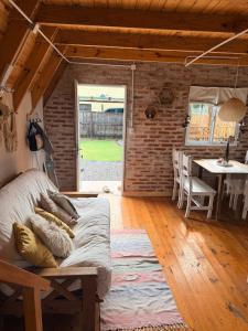 a bedroom with a bed and a dining room with a table at Salesta San Pedro in San Pedro