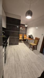 a large kitchen with a table and chairs in it at Noclegi Tyczyn in Tyczyn
