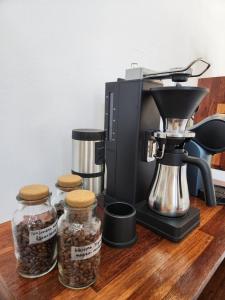 a coffee maker and three glass jars of food at Tov & Kara in Jeju