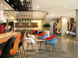 a restaurant with colorful chairs and tables in a lobby at Ibis Bandung Pasteur in Bandung