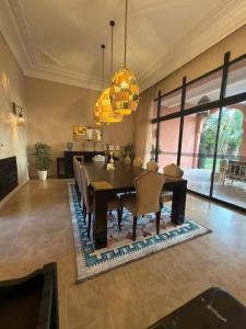 a dining room with a table and chairs at Royal Moroccan House in Marrakesh