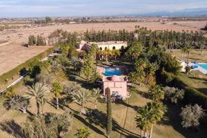 an aerial view of a house with palm trees at Royal Moroccan House in Marrakesh