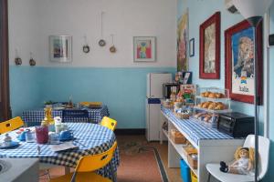 a kitchen with two tables with food on them at B&B Amarantha Gothica Genoa in Genoa