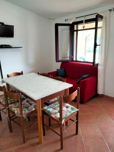 a living room with a table and chairs and a couch at Casa Antonietta in Santa Lucia
