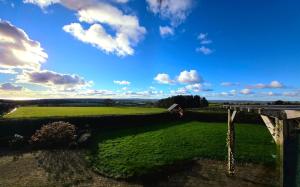 a view of a green field and a wooden bridge at Antrim Heights B&B Panoramic Views & Free Parking in Antrim